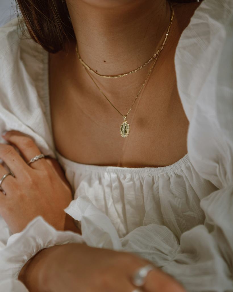 Layered Nishtha chains and stacked rings worn with white linen
