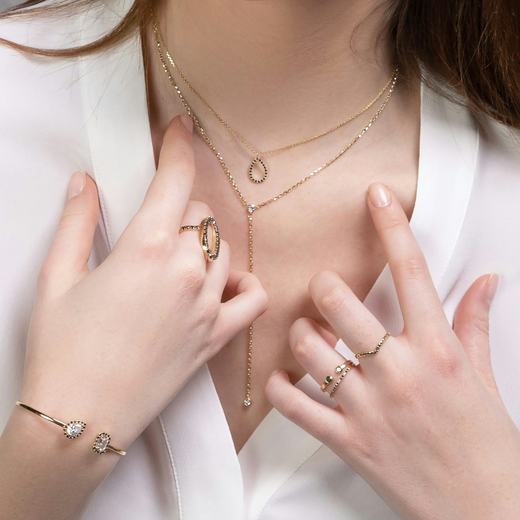 Layered Chandrika chains with a linen blazer