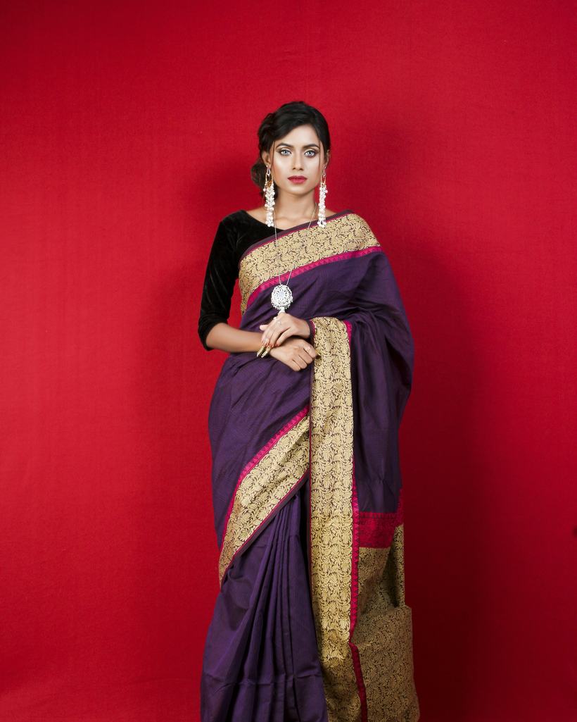 A customer wearing a Nishtha bridal-look set with a handwoven silk saree